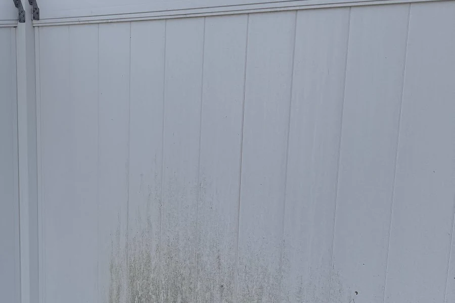 Algae-stained fence before cleaning by Callahan Exterior Cleaning